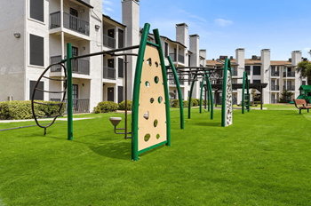 a playground with a surfboard in the middle of an apartment complex
